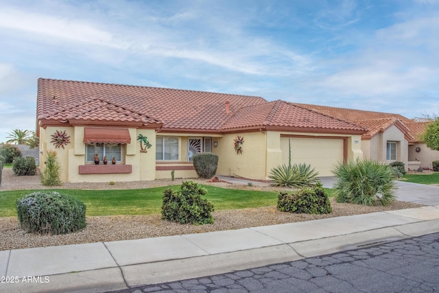 mediterranean / spanish home with a garage and a front yard