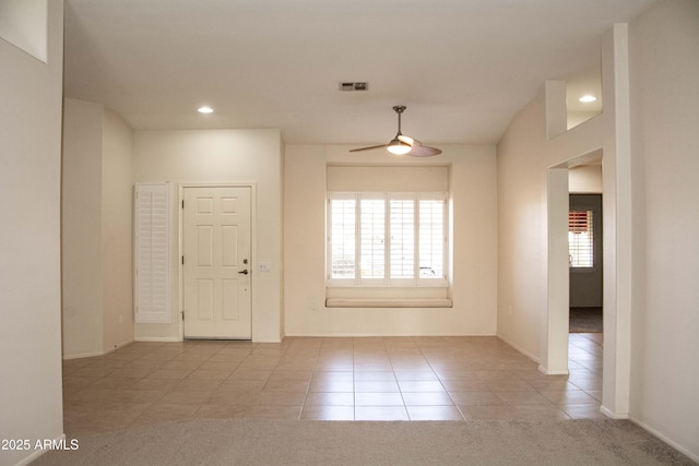 interior space featuring ceiling fan and light colored carpet