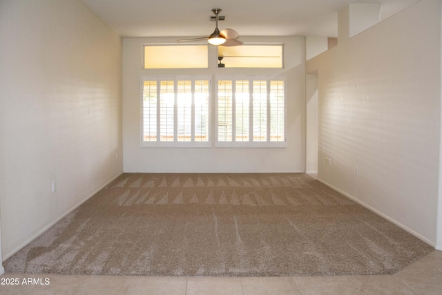 empty room featuring ceiling fan and light colored carpet