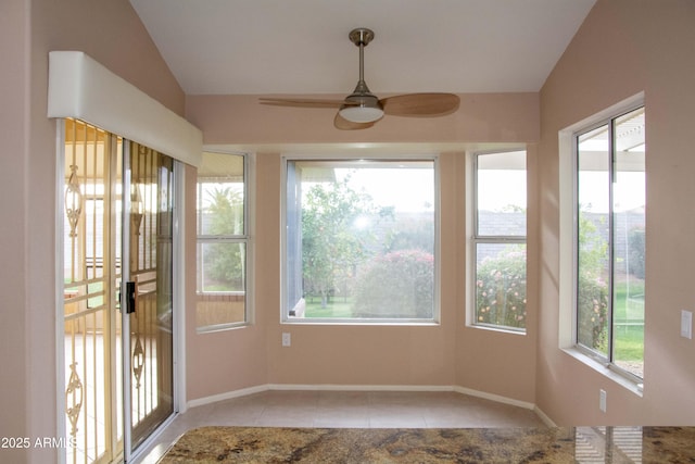 unfurnished sunroom with vaulted ceiling and ceiling fan