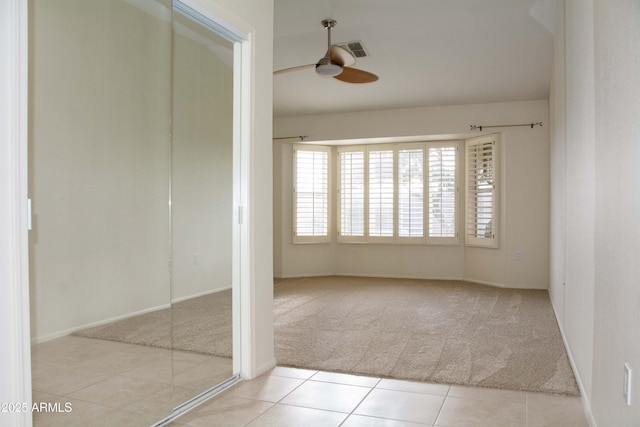 unfurnished room with light carpet and ceiling fan