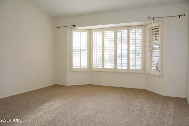 carpeted empty room featuring plenty of natural light