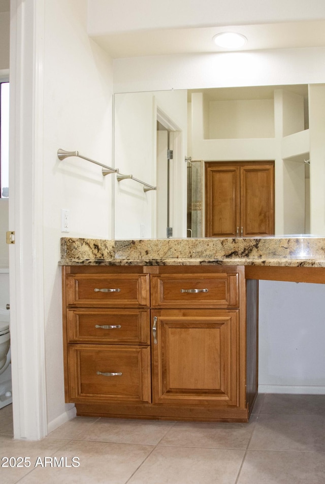 bathroom featuring tile patterned floors, toilet, and vanity