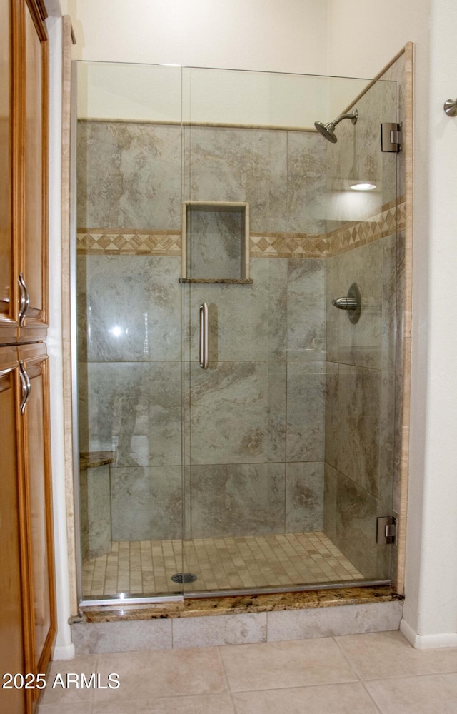 bathroom featuring tile patterned floors and an enclosed shower