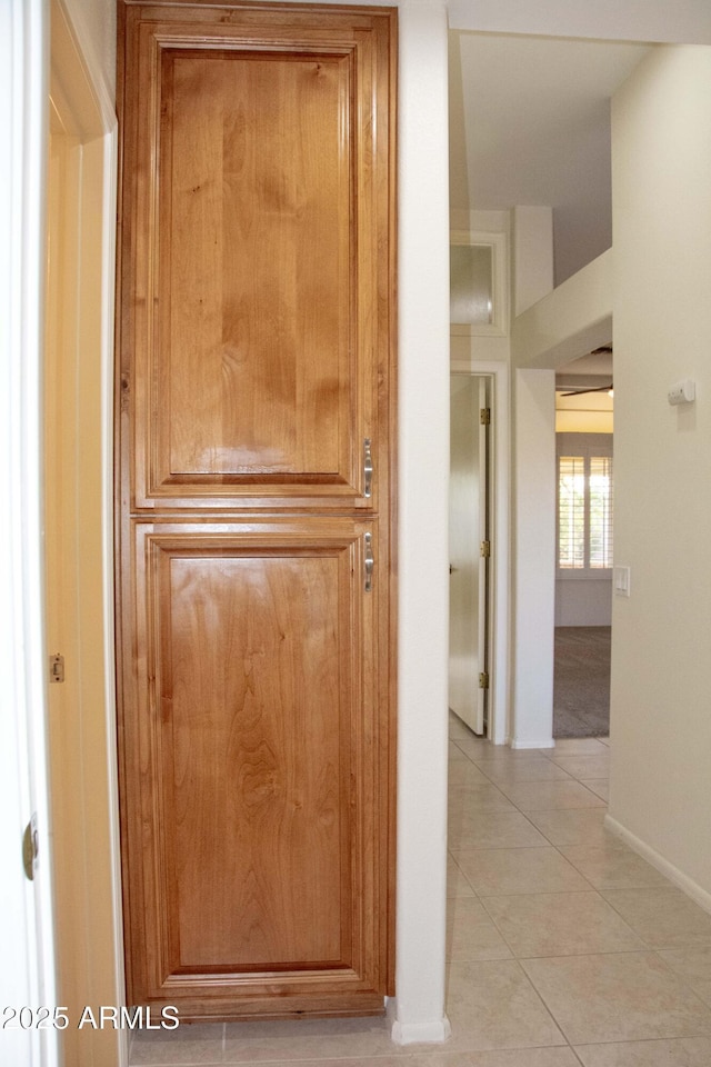 hall featuring light tile patterned floors