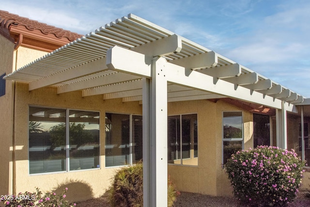 view of property exterior with a pergola