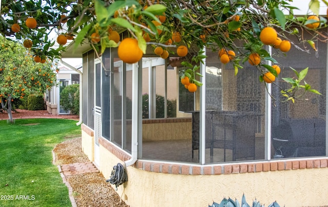 exterior space featuring a lawn and a sunroom