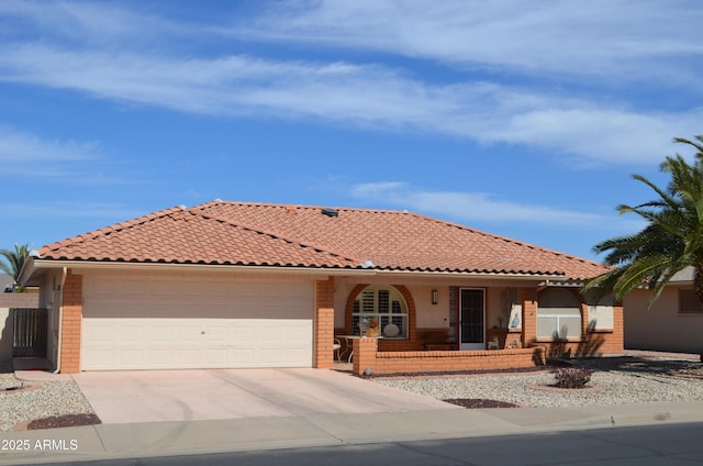 view of front facade with a garage, concrete driveway, brick siding, and a tiled roof