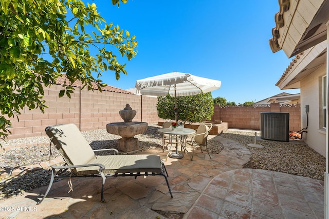 view of patio / terrace with a fenced backyard and central AC