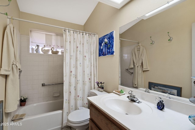 bathroom with a skylight, shower / tub combo with curtain, vanity, and toilet