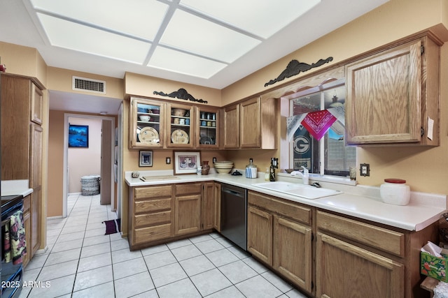 kitchen featuring a sink, visible vents, light countertops, dishwasher, and brown cabinetry