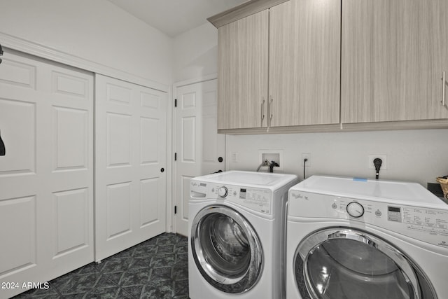 laundry room with cabinets and washer and clothes dryer