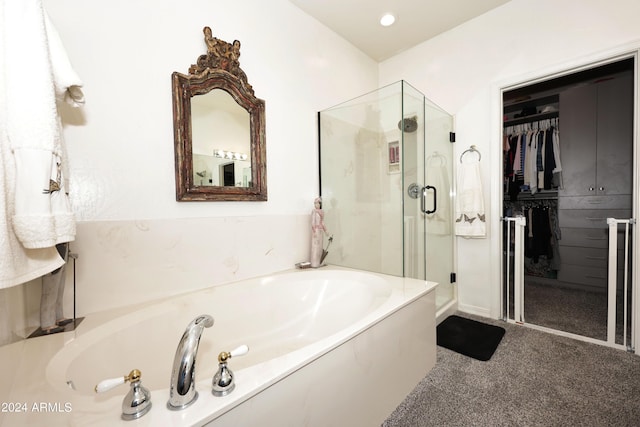 bathroom featuring shower with separate bathtub