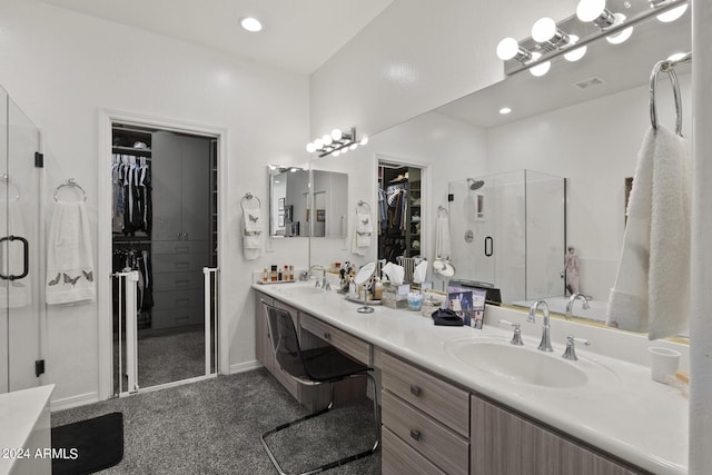 bathroom with vanity and a shower with shower door