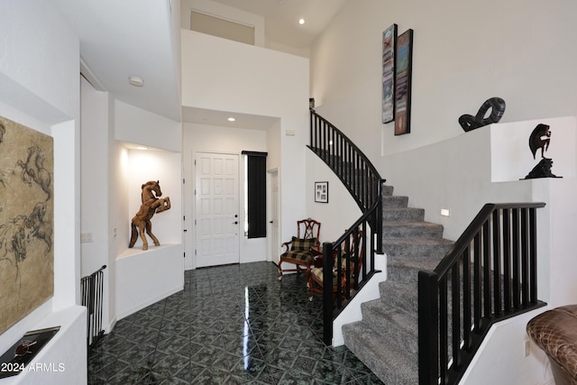 foyer entrance with a towering ceiling