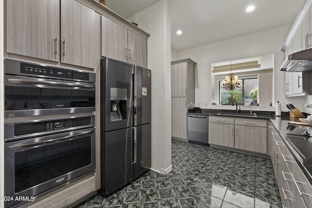 kitchen featuring extractor fan, appliances with stainless steel finishes, decorative light fixtures, sink, and an inviting chandelier