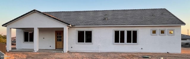 rear view of property with stucco siding