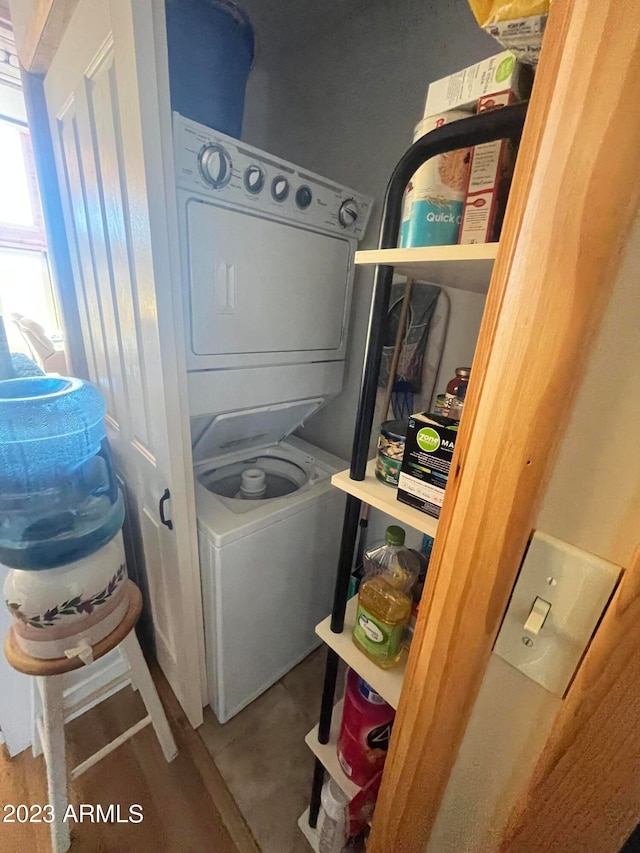 laundry area with stacked washer / dryer