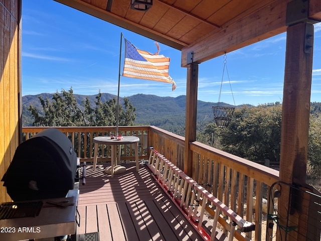 wooden terrace with a mountain view and grilling area