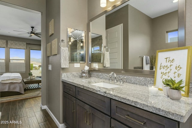 bathroom with ceiling fan and vanity