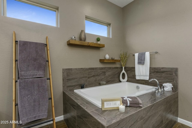 bathroom featuring tiled bath