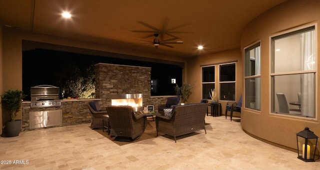 view of patio with an outdoor living space with a fireplace, area for grilling, and ceiling fan