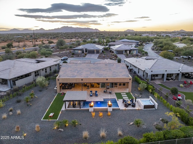 aerial view at dusk featuring a mountain view