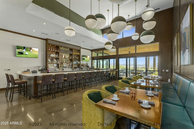 bar featuring pendant lighting and a high ceiling