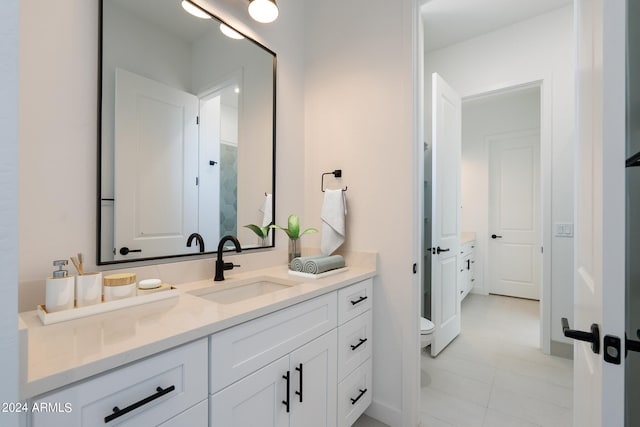 bathroom with vanity, toilet, and tile patterned floors