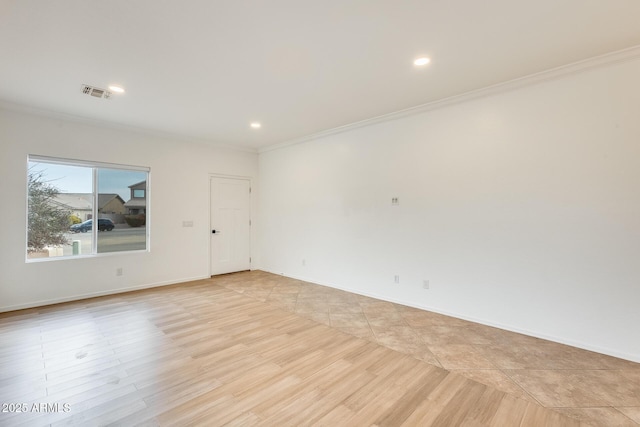 tiled spare room with ornamental molding