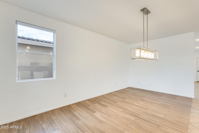 empty room with light hardwood / wood-style flooring