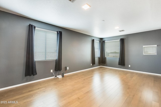 spare room featuring light hardwood / wood-style flooring