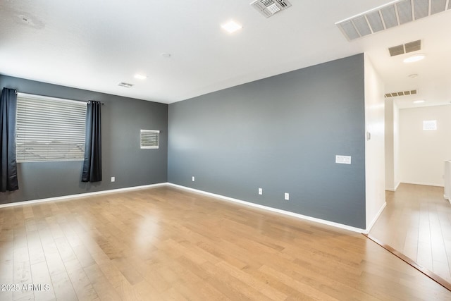 unfurnished room with light wood-type flooring