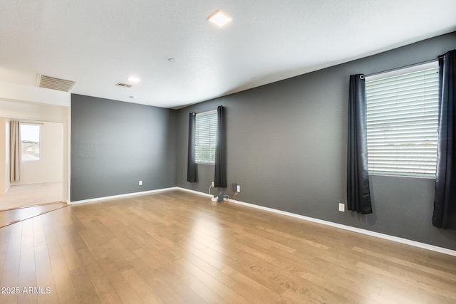 spare room with light hardwood / wood-style flooring