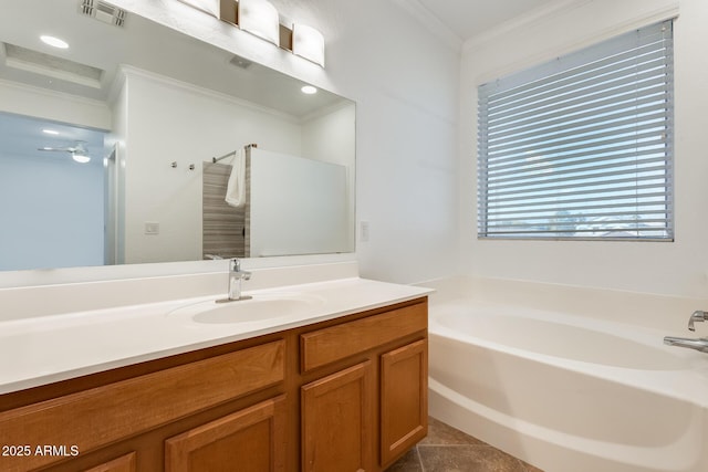 bathroom featuring a washtub, vanity, tile patterned floors, and crown molding