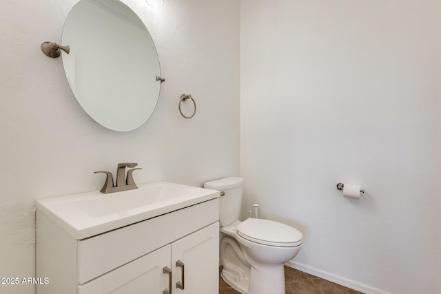 bathroom with tile patterned flooring, vanity, and toilet