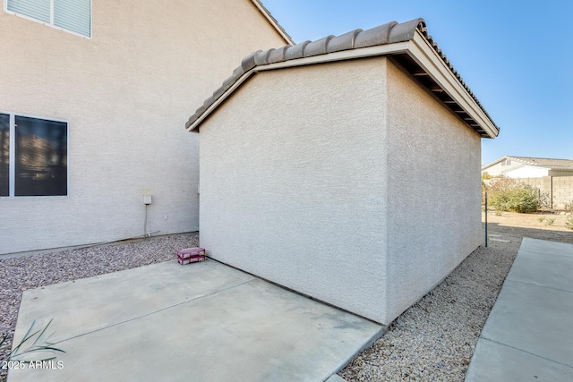 view of side of property featuring a patio area