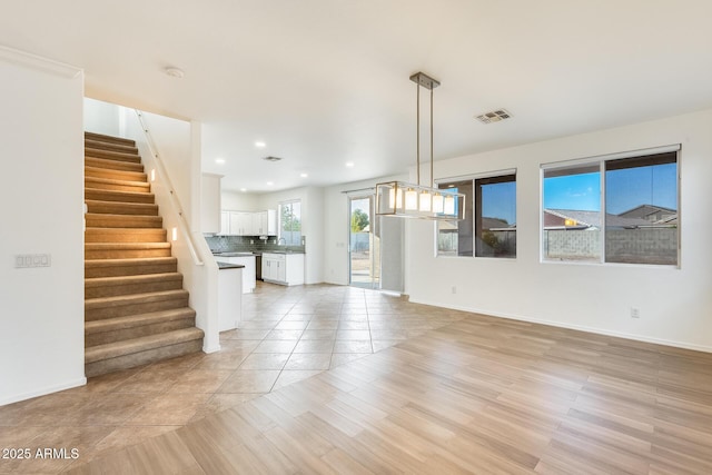 interior space with light tile patterned floors and sink