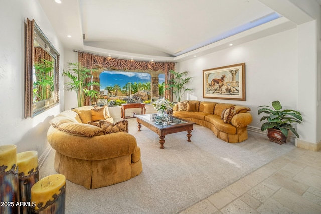 living room with lofted ceiling and a raised ceiling