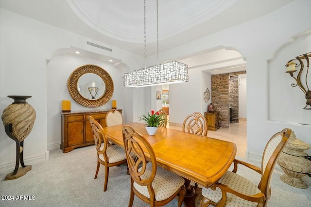 dining room featuring a raised ceiling