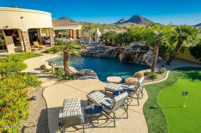 view of pool featuring a mountain view and a patio