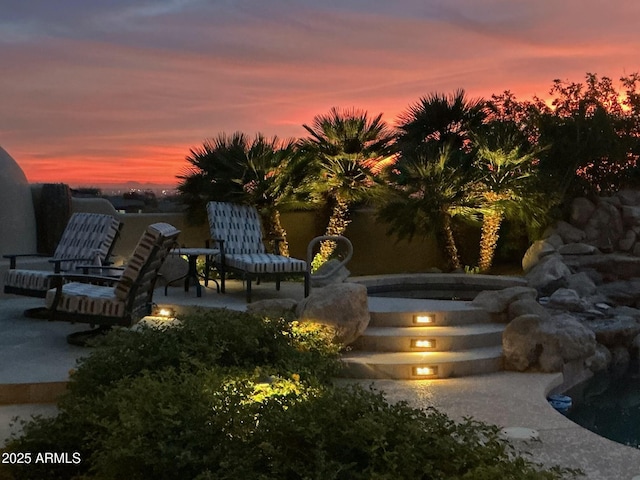 view of patio terrace at dusk