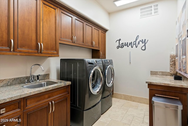 laundry room with separate washer and dryer, sink, and cabinets