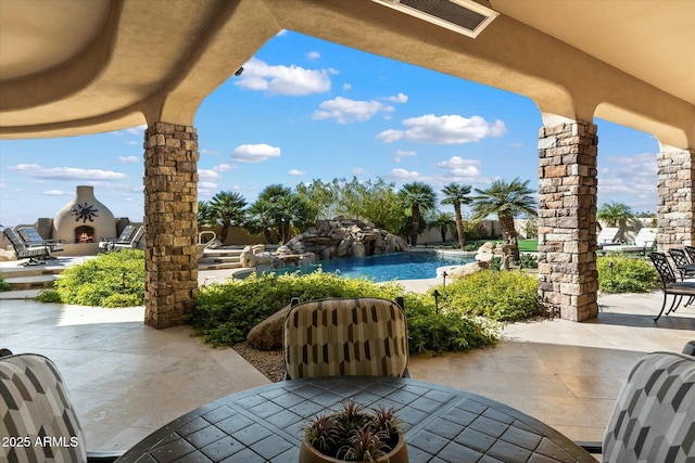 view of patio featuring pool water feature