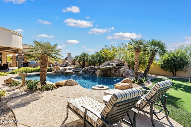 view of pool with a patio and pool water feature