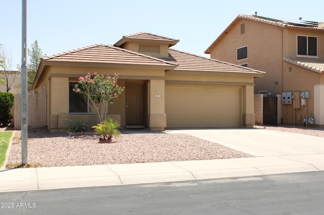 3559 N 143rd Ave, Goodyear, AZ 85395 - view of front of house with stucco siding, a garage, a tile roof, concrete driveway, and fence