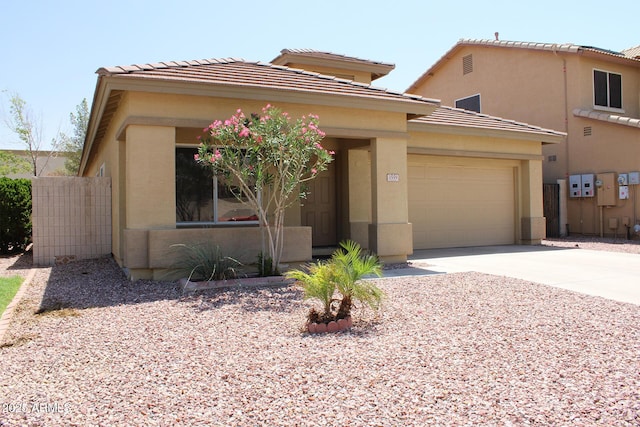 3559 N 143rd Ave, Goodyear, AZ 85395 - view of front of home with a garage, concrete driveway, a tiled roof, and stucco siding