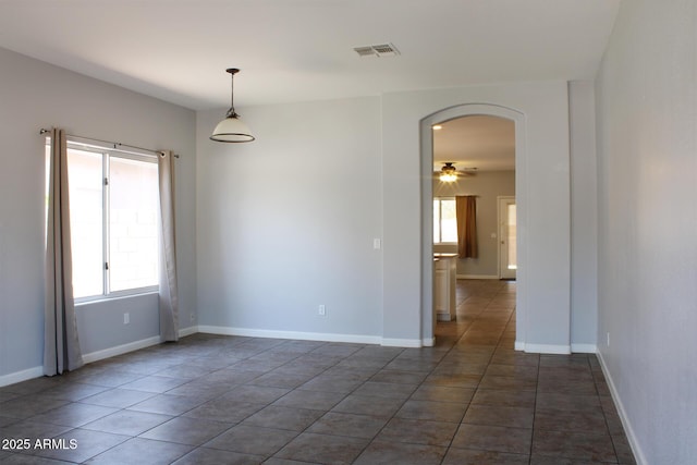 3559 N 143rd Ave, Goodyear, AZ 85395 - spare room featuring plenty of natural light, arched walkways, a ceiling fan, and baseboards