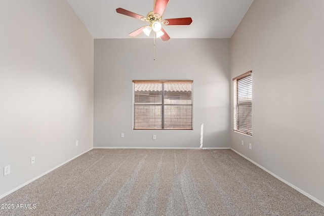 spare room with baseboards, a ceiling fan, and carpet flooring