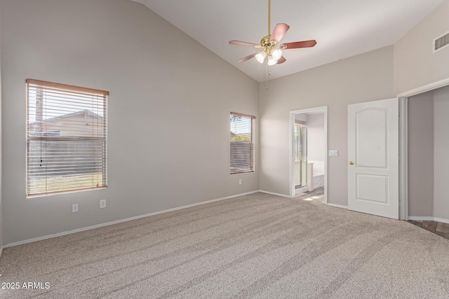 unfurnished bedroom with visible vents, baseboards, carpet floors, high vaulted ceiling, and ensuite bath